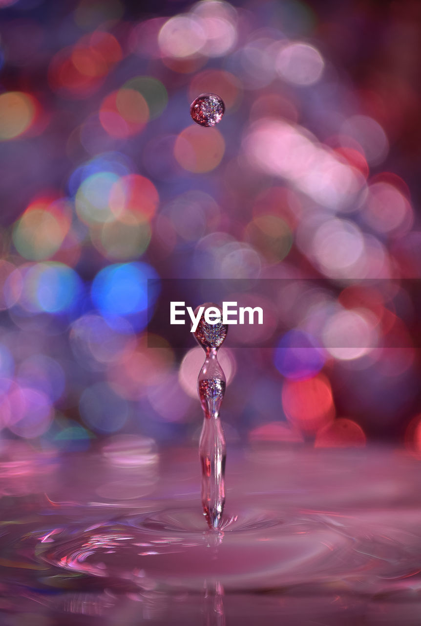 CLOSE-UP OF DROP FALLING ON WATER SURFACE