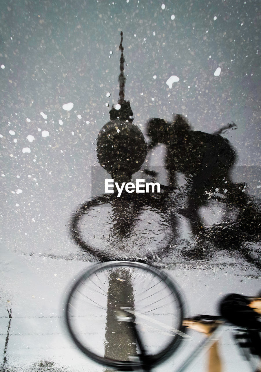 SHADOW OF MAN ON BICYCLE IN SNOW