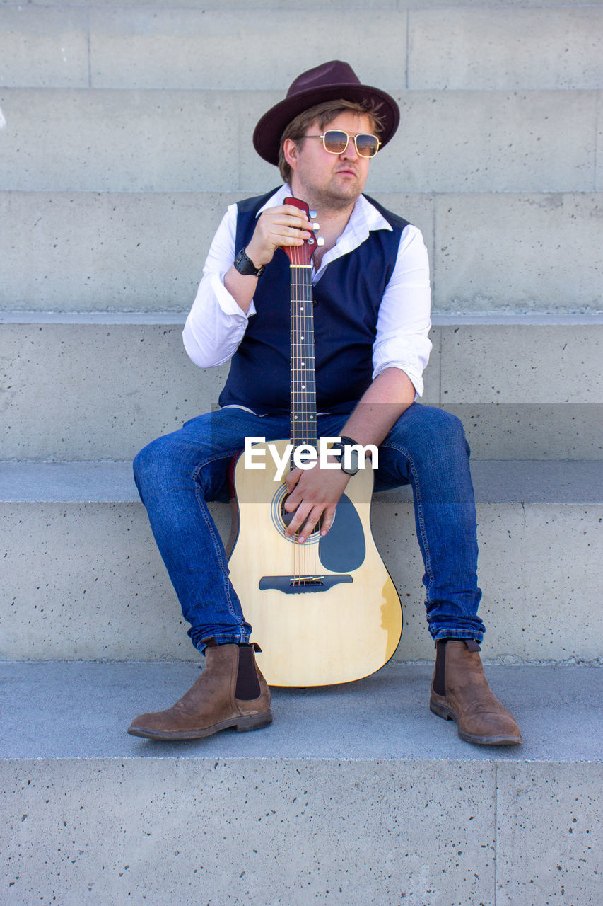 Portrait of young man playing guitar