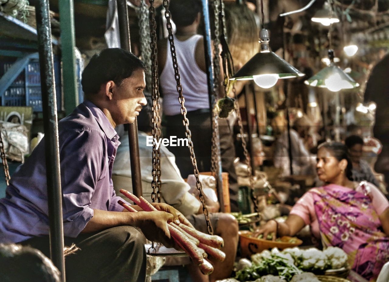 MAN STANDING IN MARKET