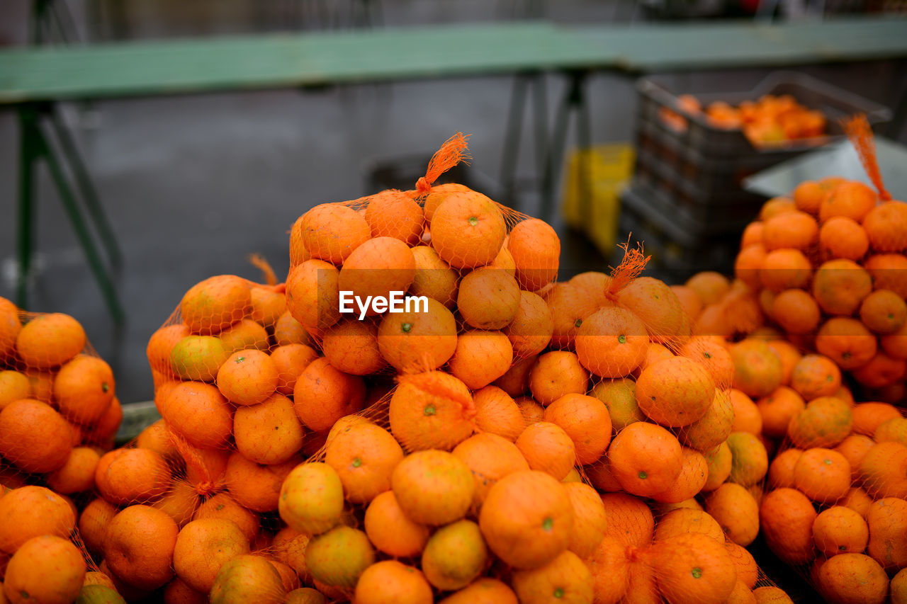 Close-up of oranges in netting at market