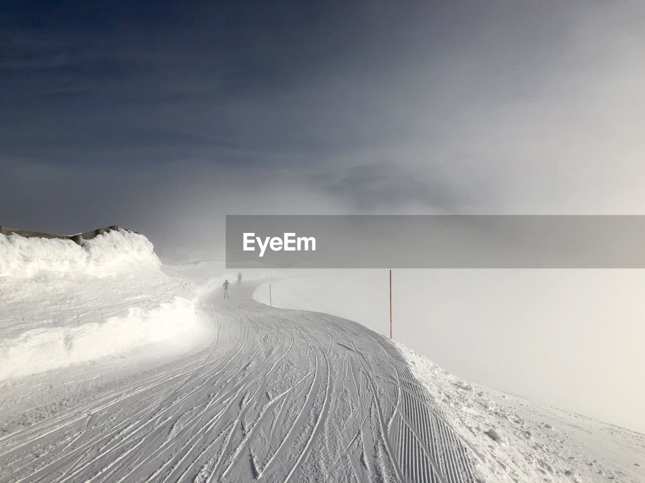 Snow covered land against sky