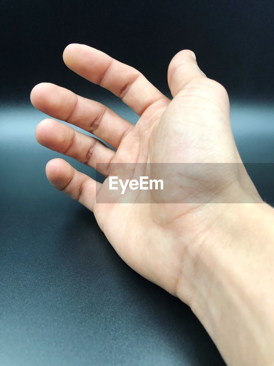 Close-up of hands against gray table