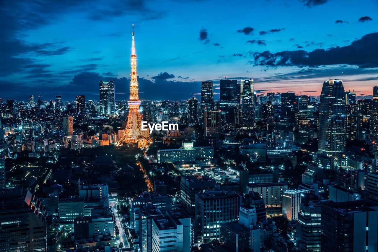 Illuminated cityscape against sky at night