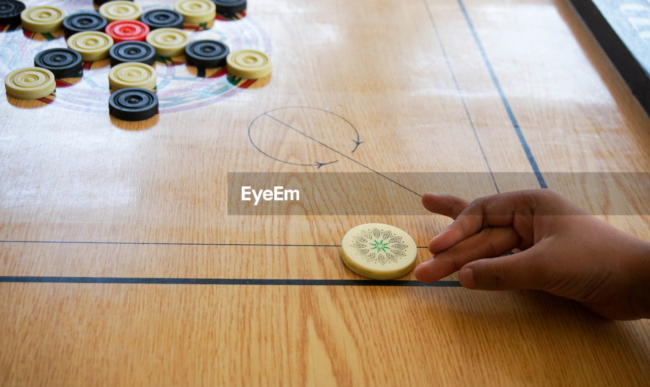 Cropped hand playing carrom