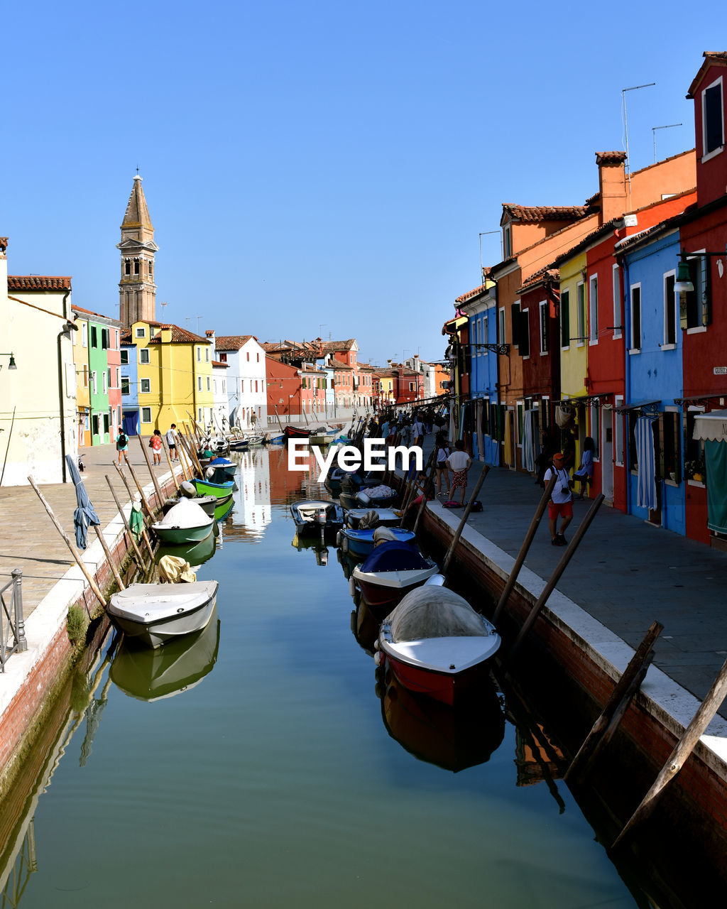 BOATS MOORED BY CANAL AGAINST CLEAR SKY