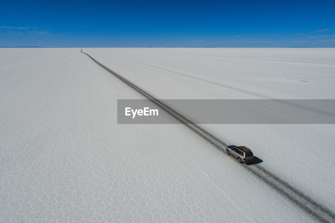 Car crossing the sal flat from aerial view