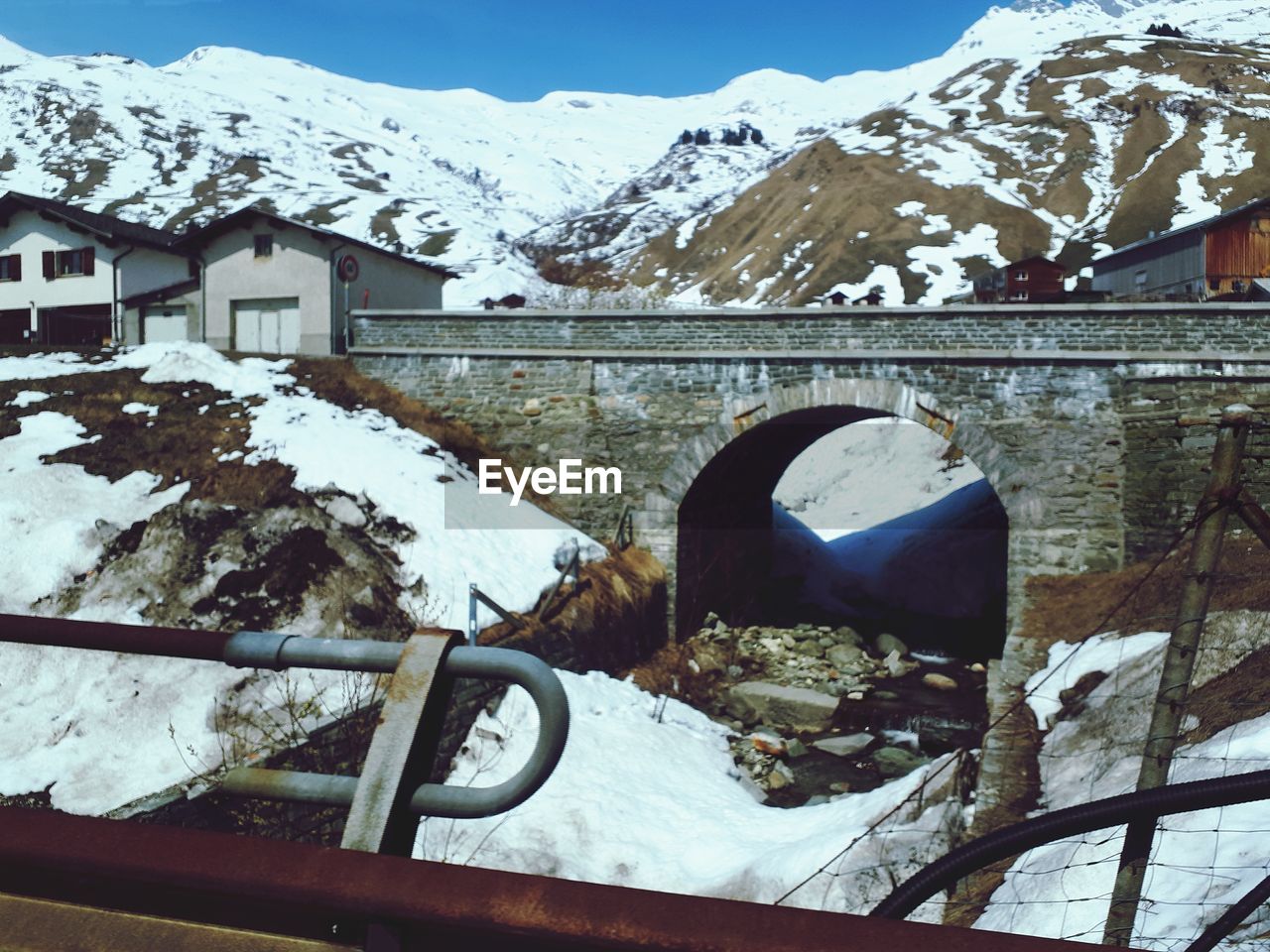 Snow covered buildings against mountain