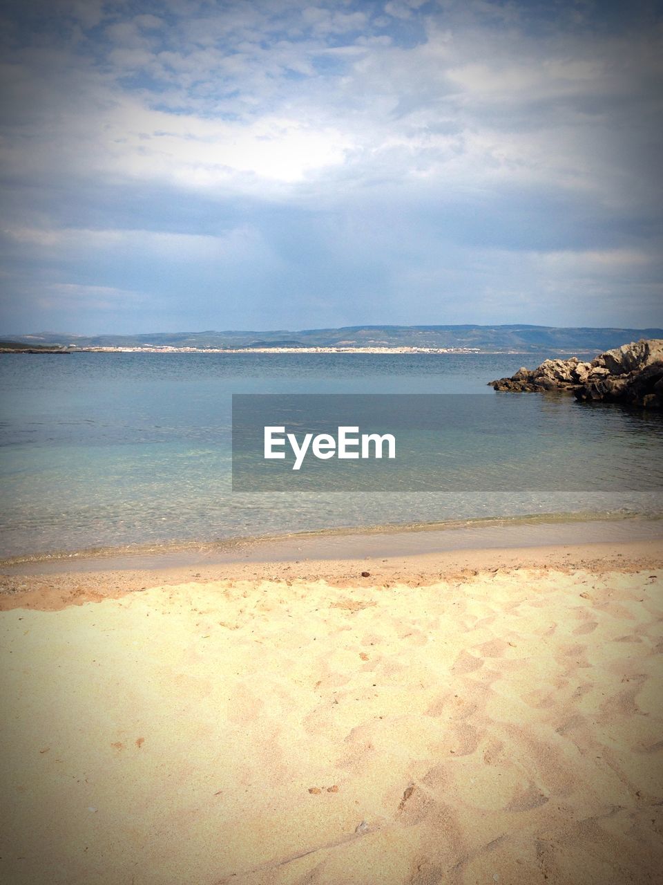 Scenic view of beach by sea against sky