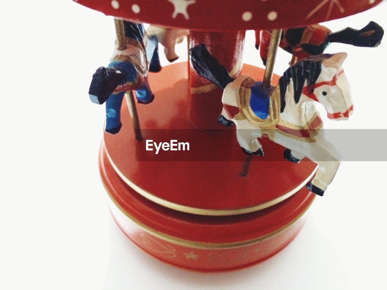 Close-up of carousel toy against white background