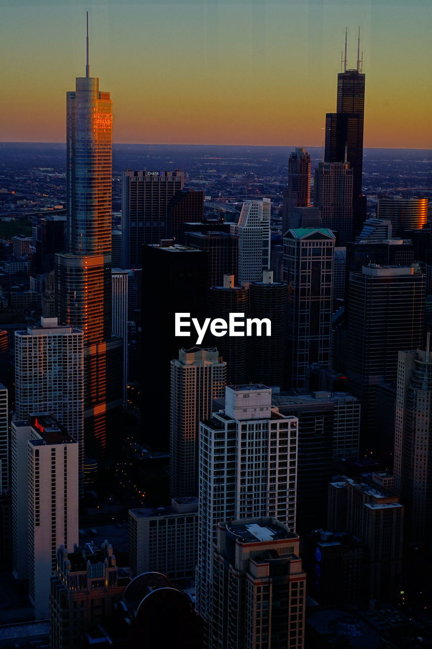 AERIAL VIEW OF BUILDINGS AT SUNSET