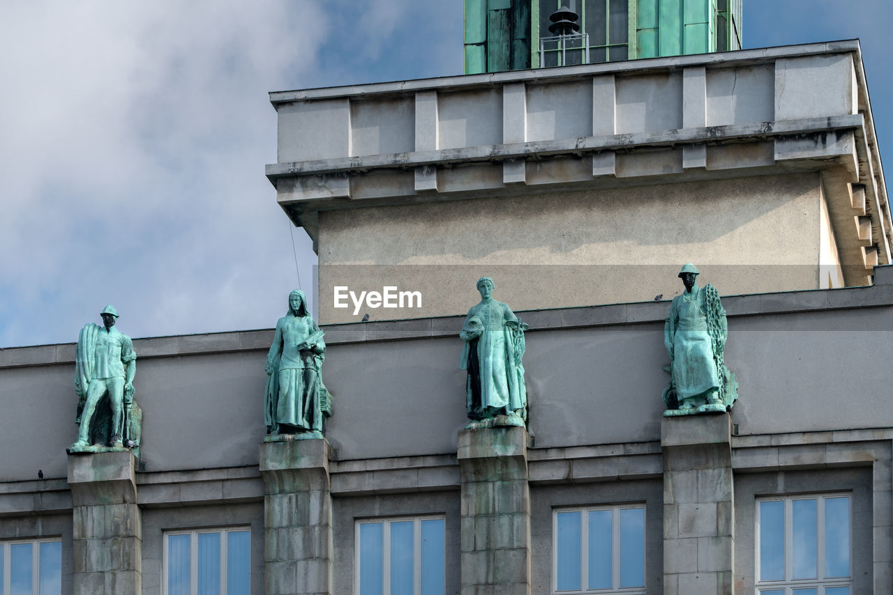 architecture, urban area, blue, building exterior, built structure, landmark, statue, sculpture, facade, sky, low angle view, no people, downtown, day, history, the past, city, nature, human representation, cloud, building, representation, travel destinations, outdoors, craft, travel