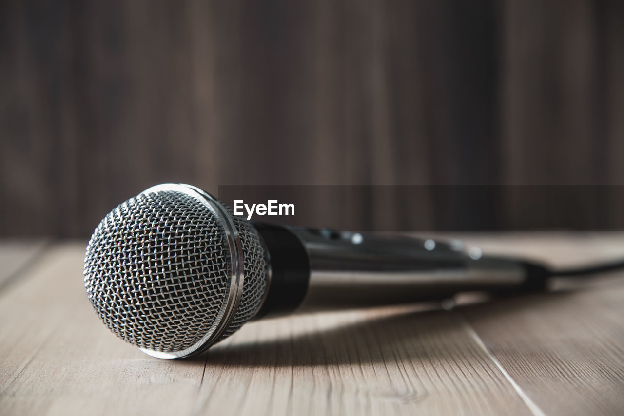 Close-up of microphone on wooden table