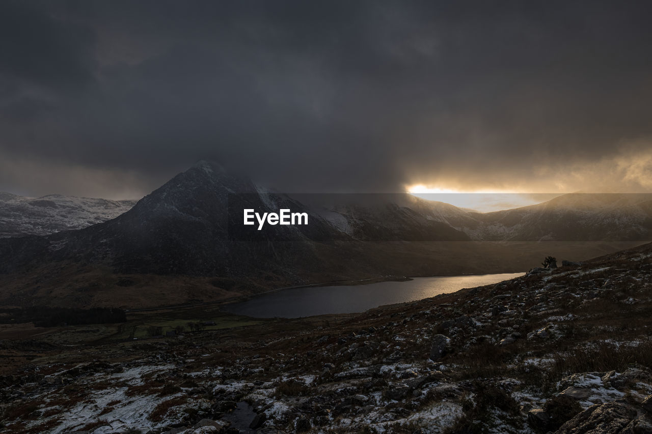 Scenic view of tryfan mountain against sky during sunset