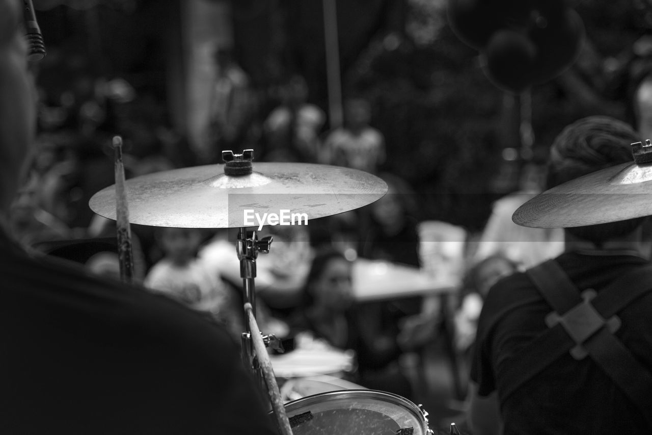 Cropped image of musician playing cymbals at music concert