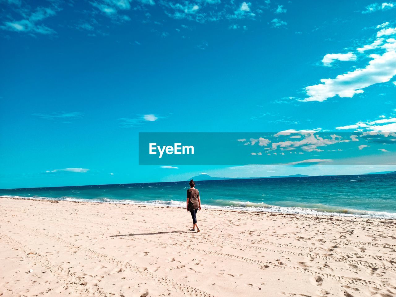 Full length of women on beach against sky