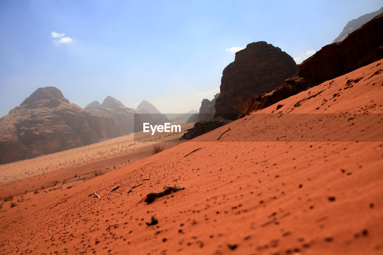 SURFACE LEVEL OF DESERT AGAINST MOUNTAIN