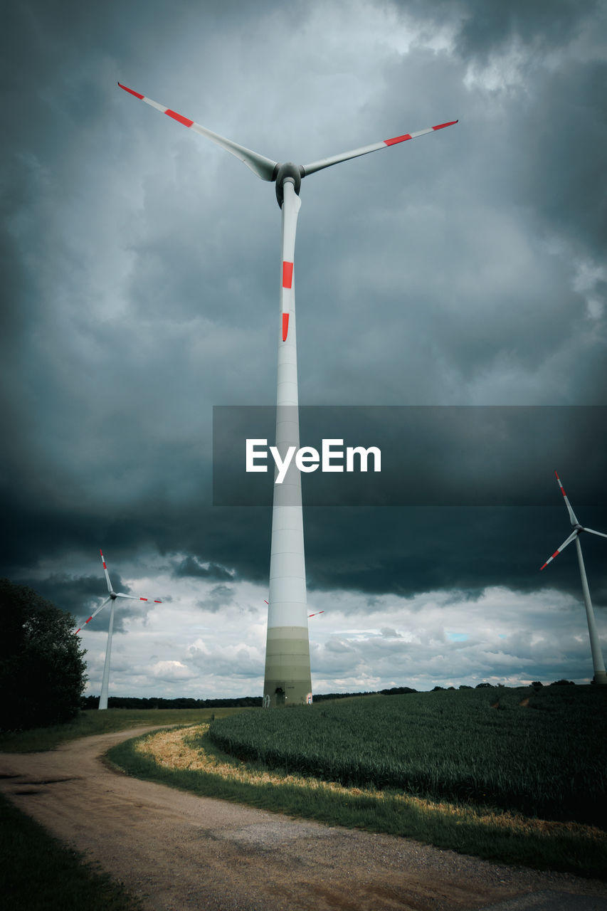 wind turbine, wind power, windmill, turbine, environment, environmental conservation, renewable energy, cloud, sky, alternative energy, power generation, wind, nature, wind farm, storm, landscape, grass, power in nature, overcast, no people, machine, beauty in nature, architecture, storm cloud, social issues, technology, outdoors, built structure, environmental issues, rural scene, transportation, day, land, field, plant, dramatic sky, cloudscape, electricity