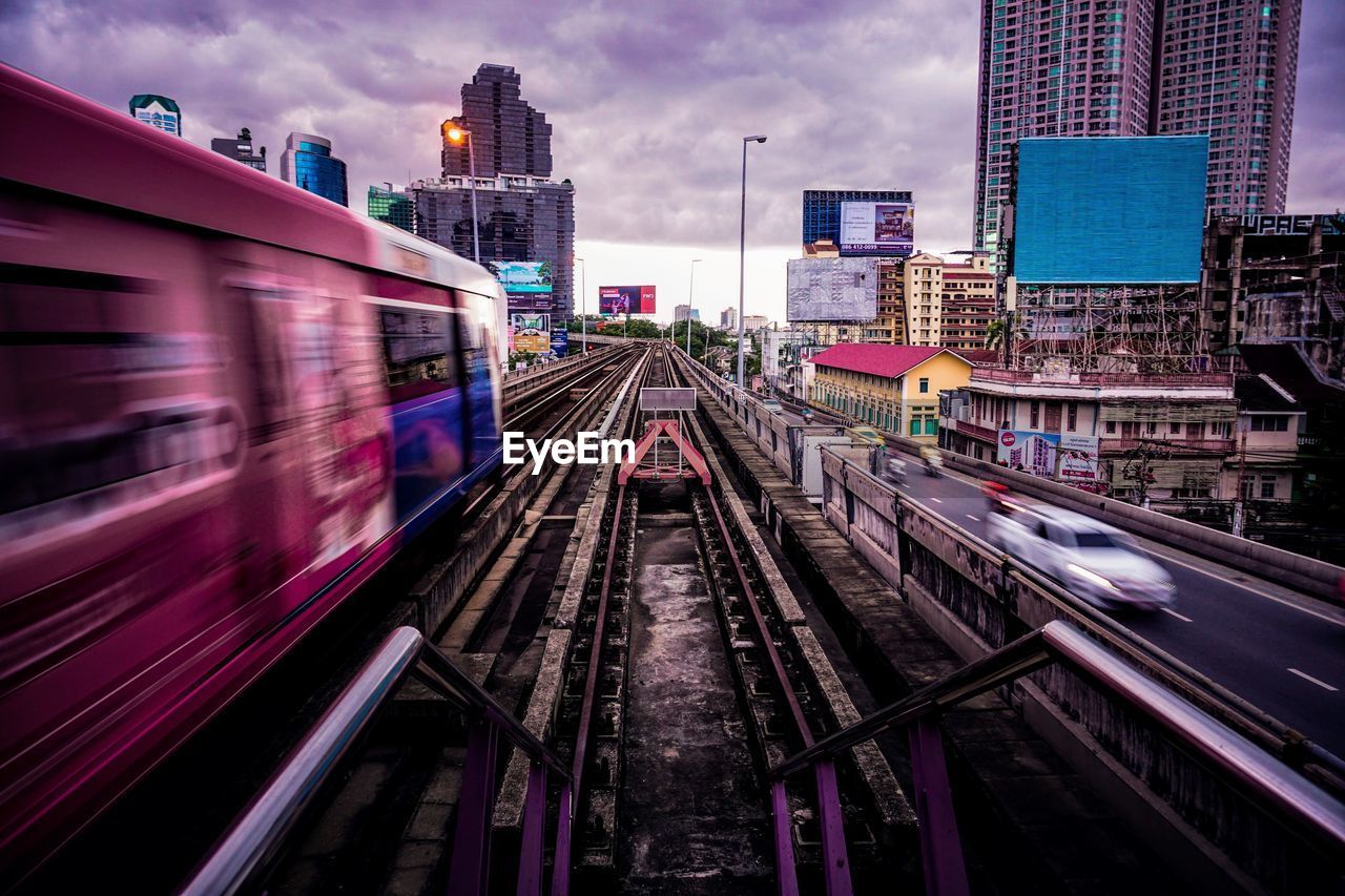 TRAIN ON RAILROAD TRACKS IN CITY