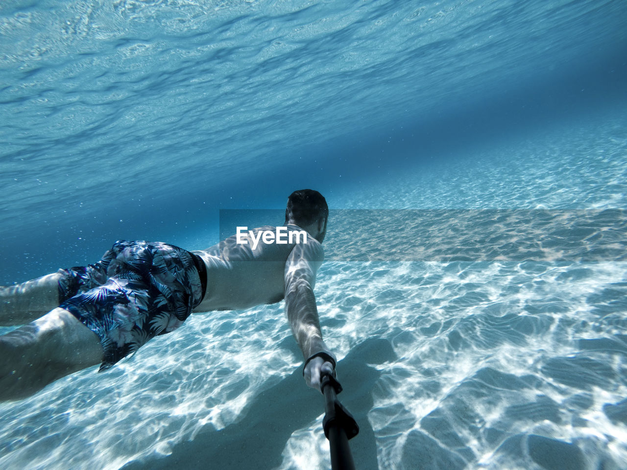 Go pro selfie of man swimming underwater