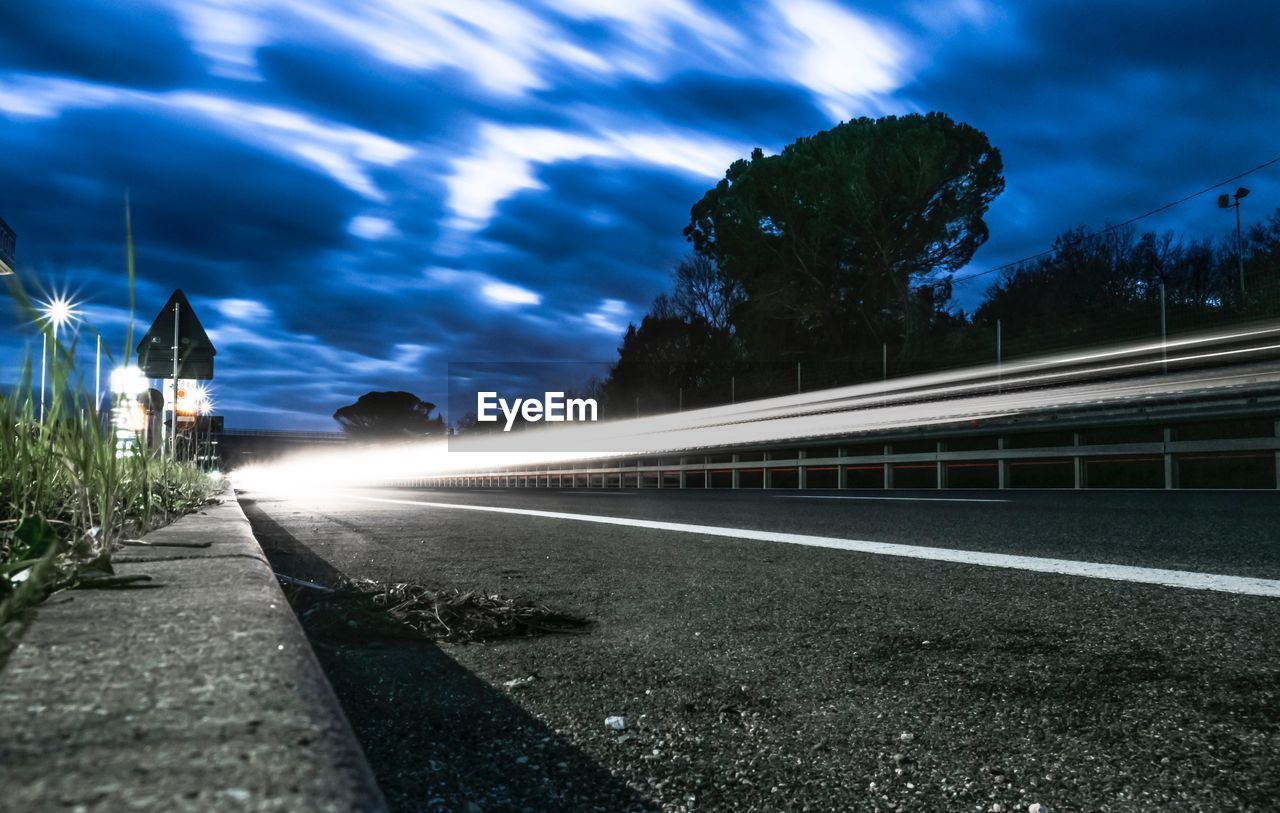 ROAD BY STREET AGAINST SKY