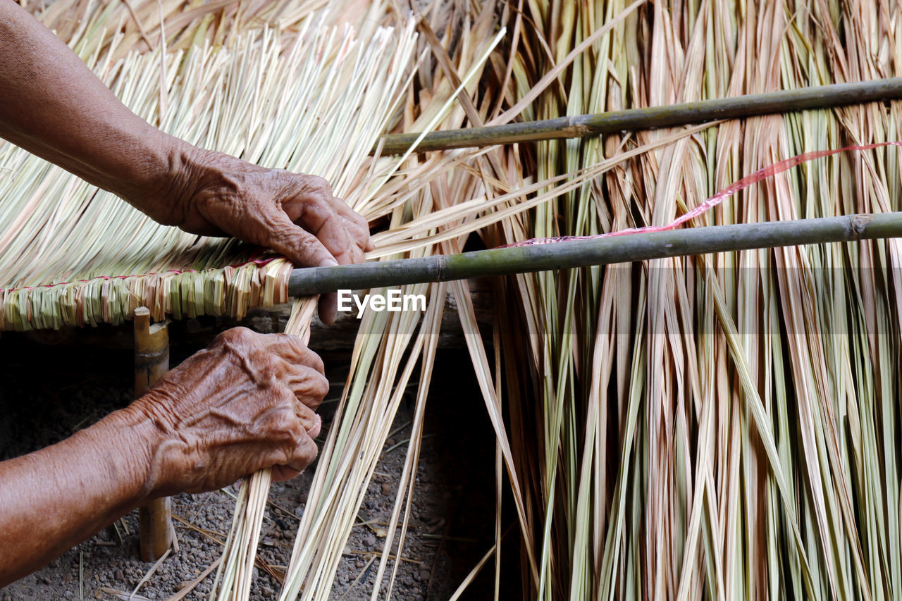 Man weaving straw at workshop