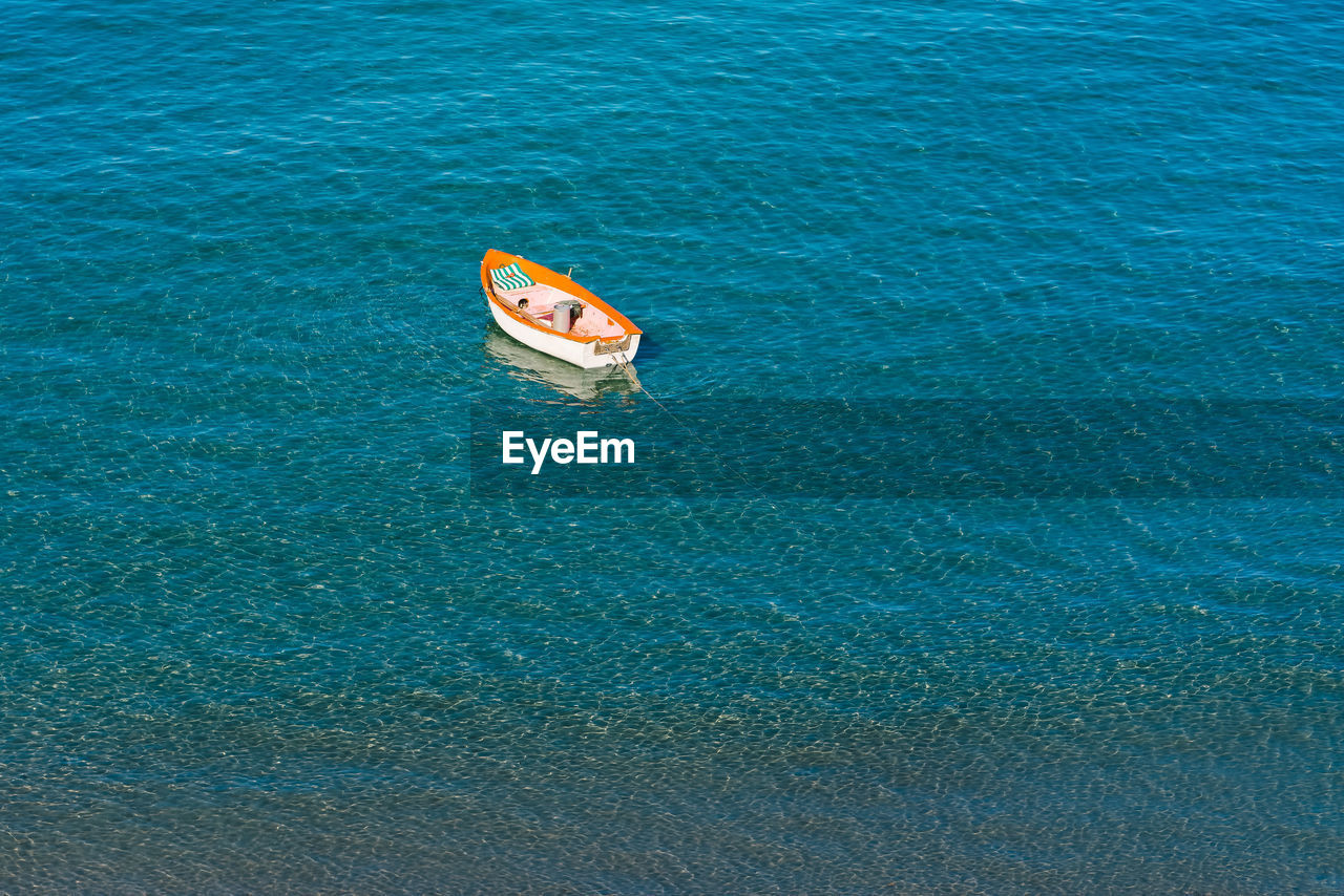 High angle view of boat anchored on sea