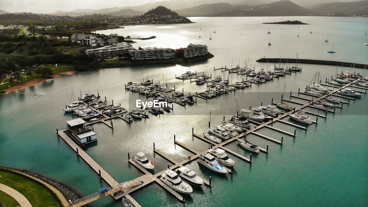 HIGH ANGLE VIEW OF BOATS IN MARINA