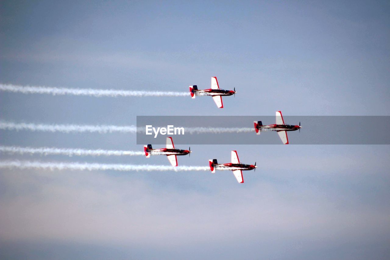 Low angle view of airplane flying against sky