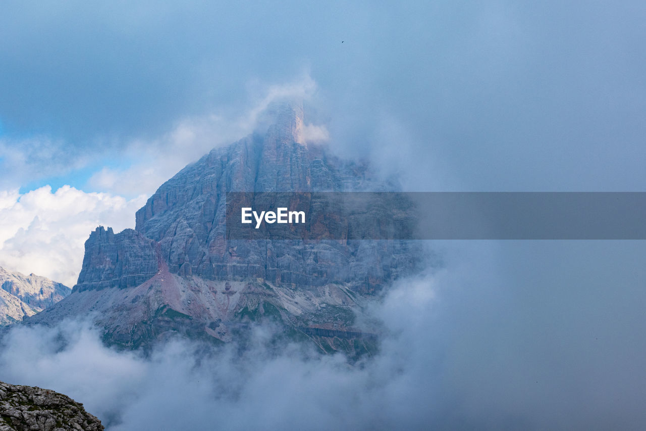 Scenic view of mountains against cloudy sky