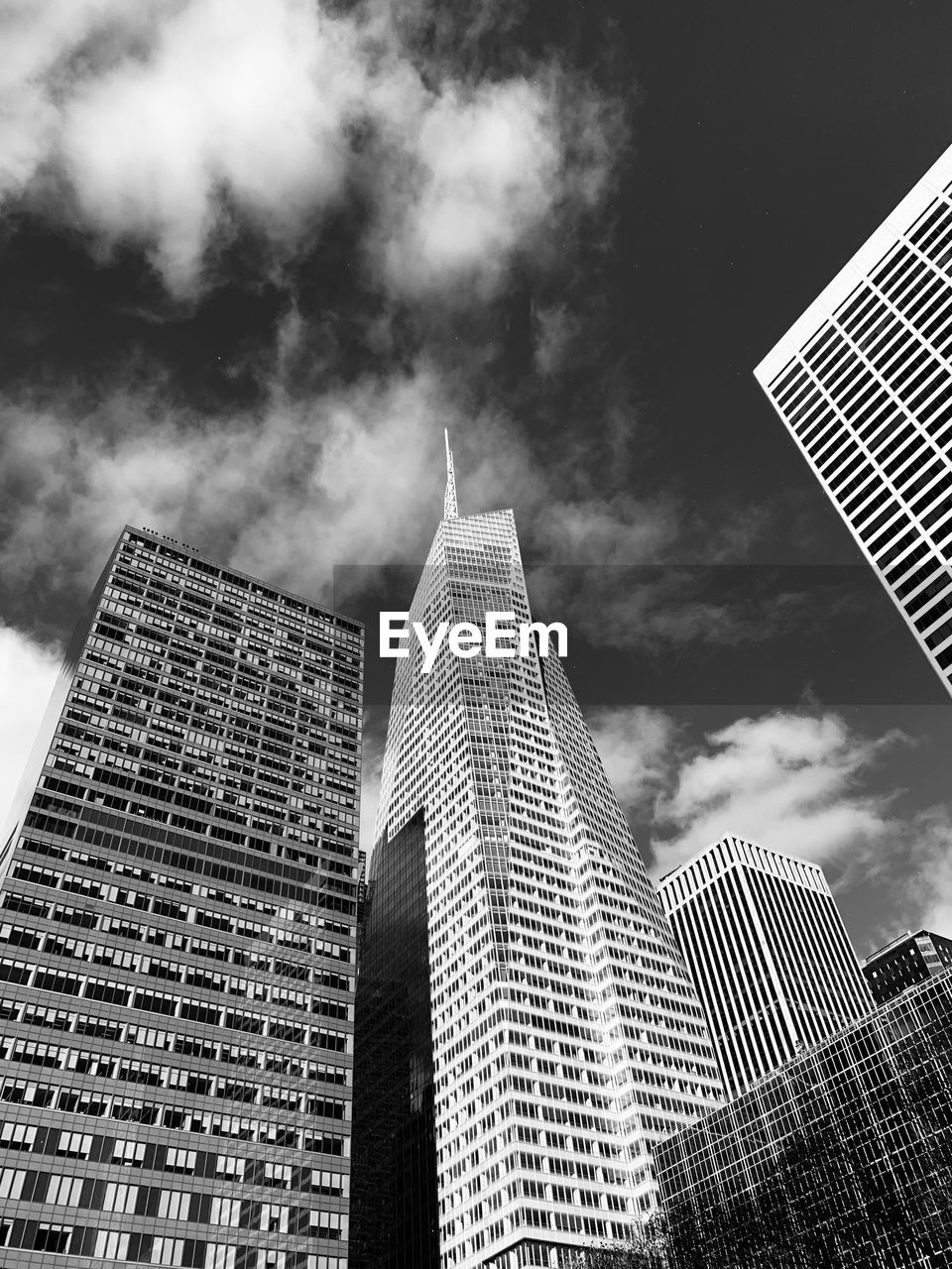 Low angle view of buildings against cloudy sky