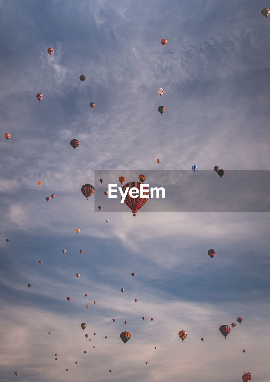 Low angle view of hot air balloons flying in sky