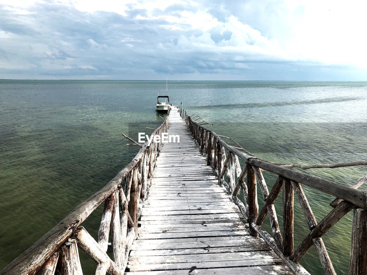 Pier over sea against sky