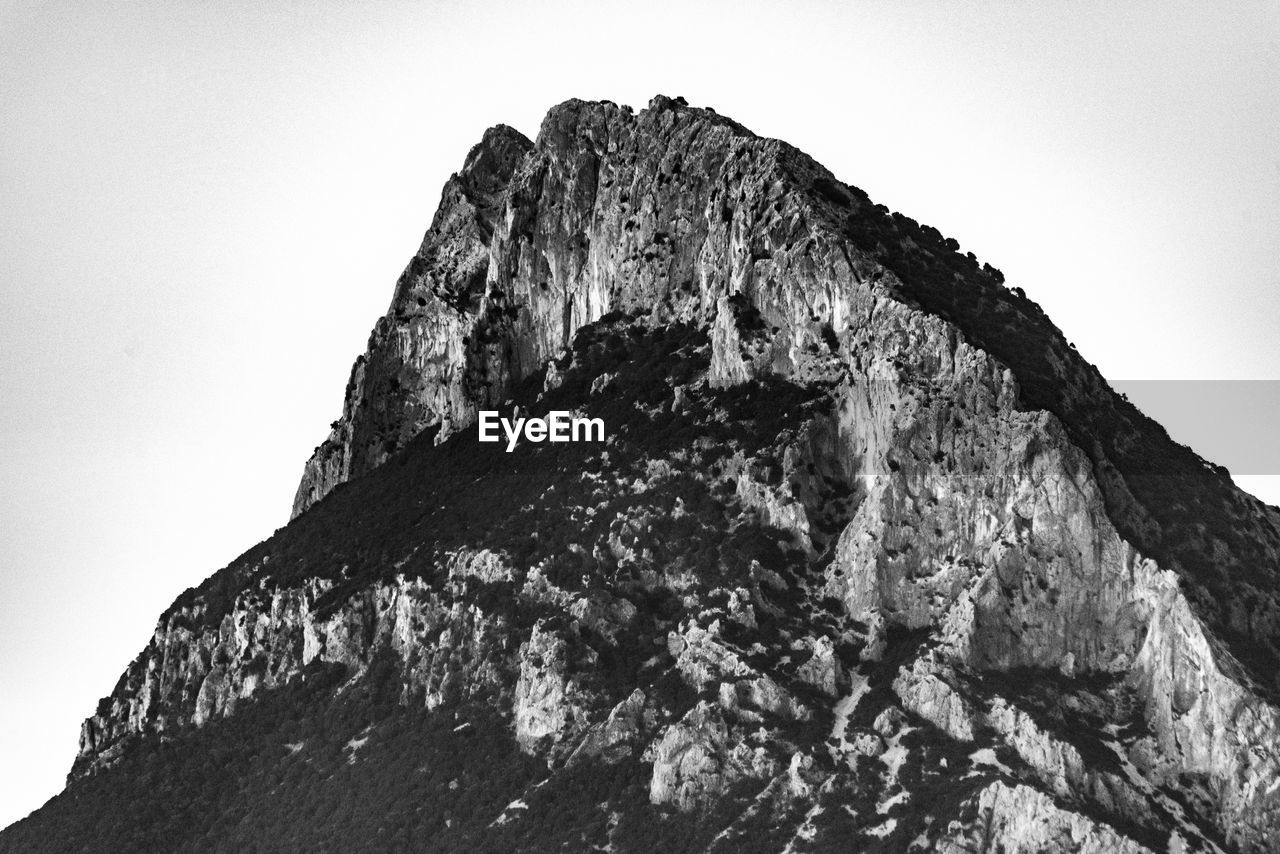 Low angle view of rock formation against clear sky