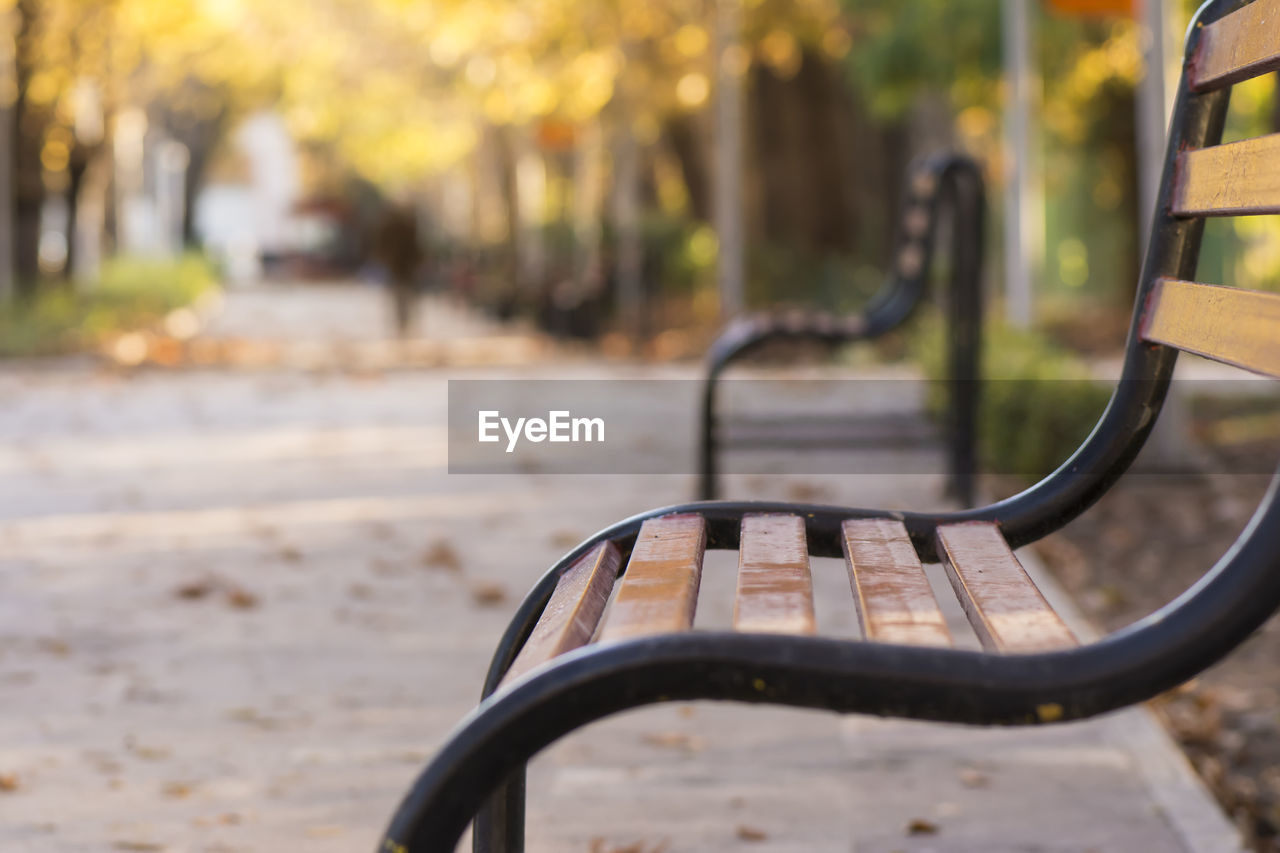 Close-up of empty bench at park