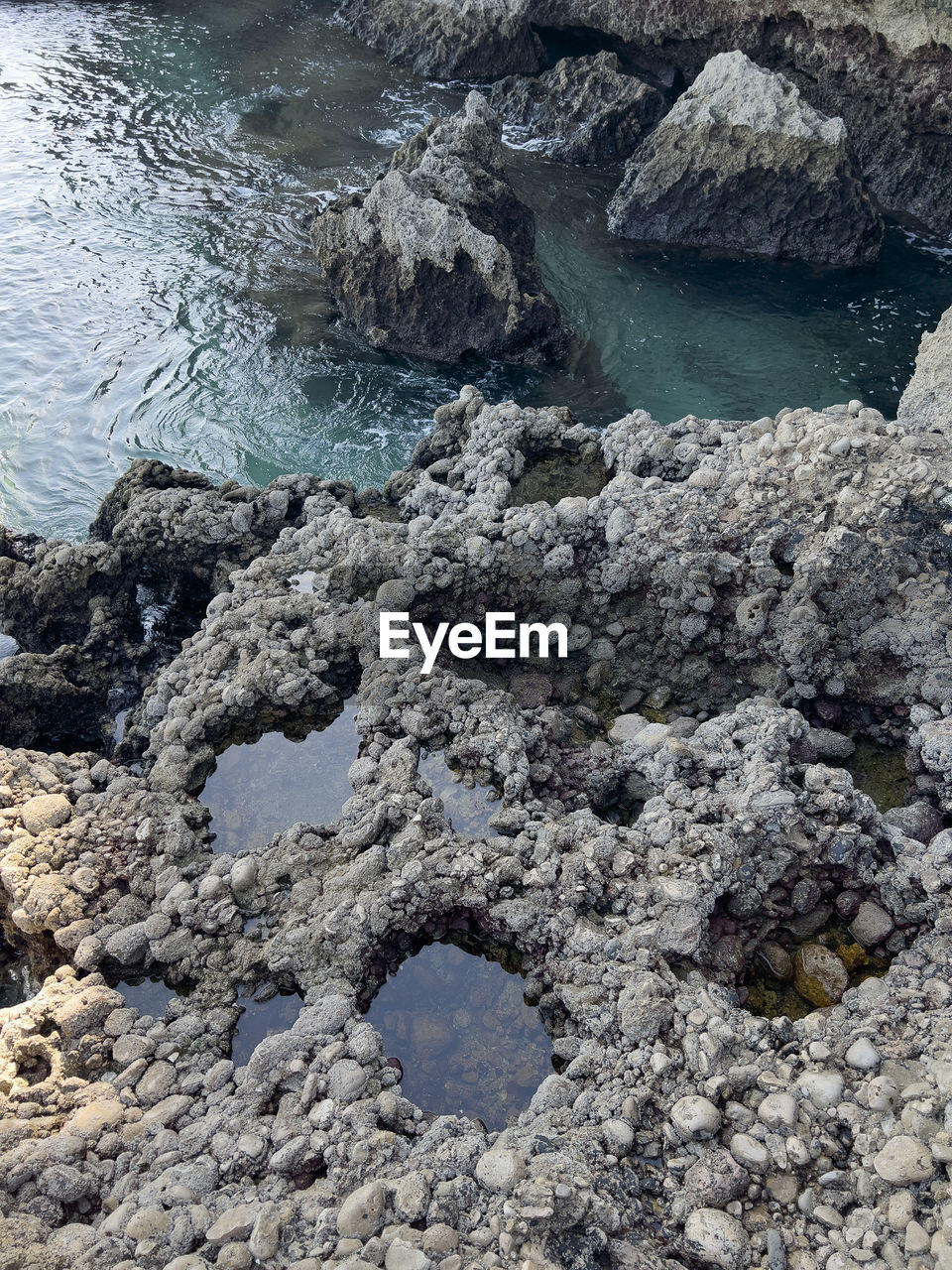 high angle view of rocks in sea