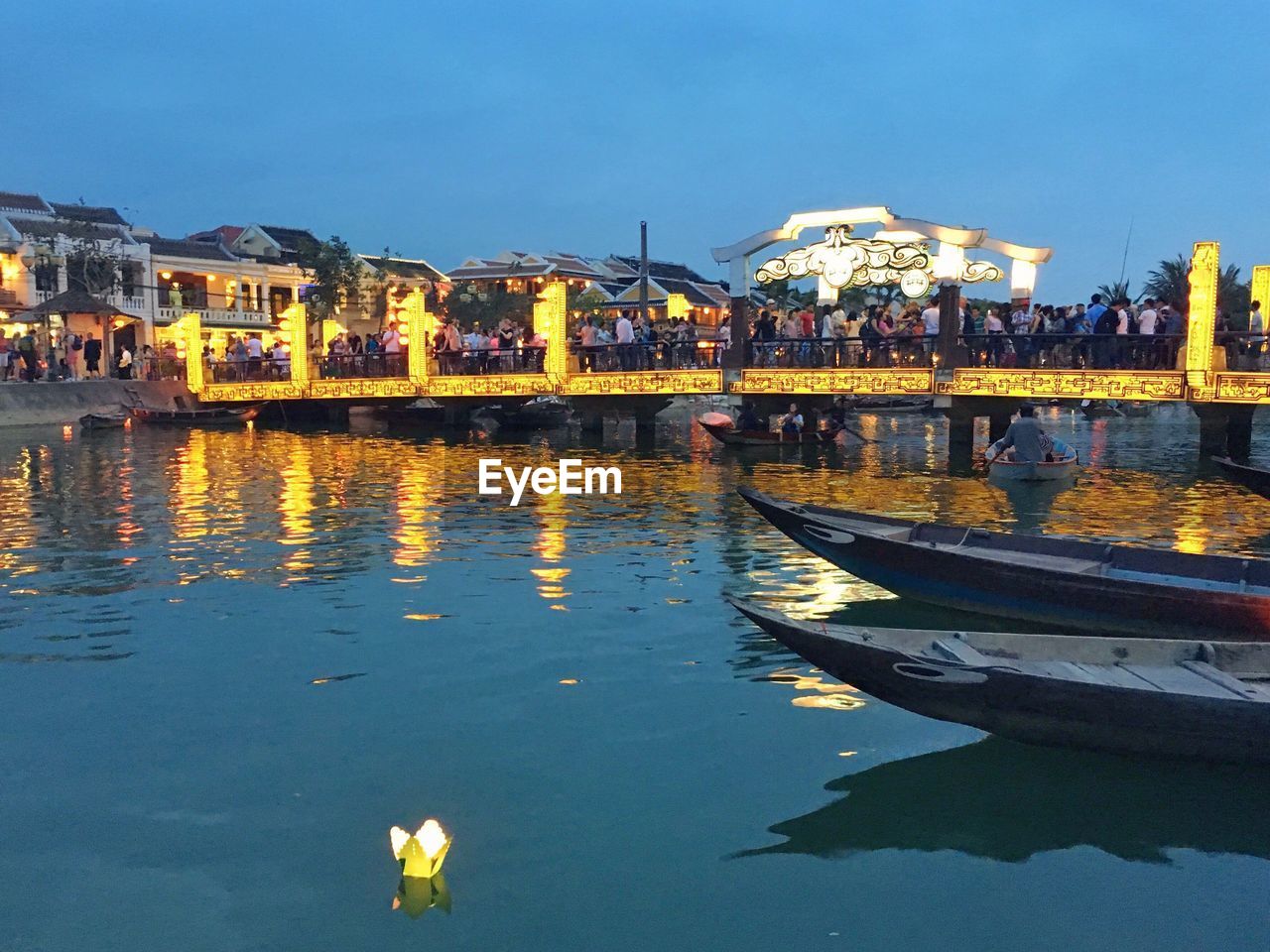 BOATS MOORED ON ILLUMINATED CITY AGAINST SKY