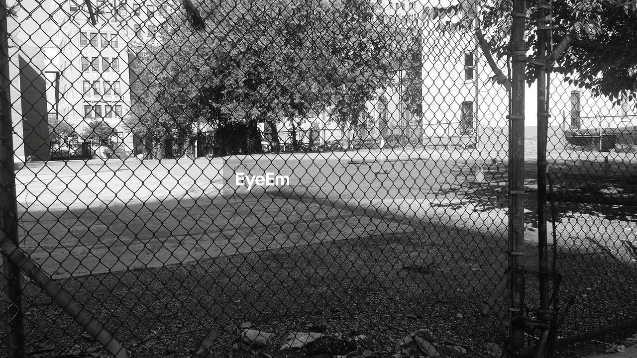 Empty town square seen through chainlink fence