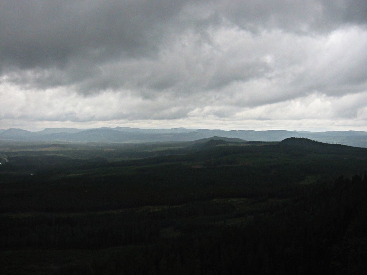 Countryside landscape against cloudy sky