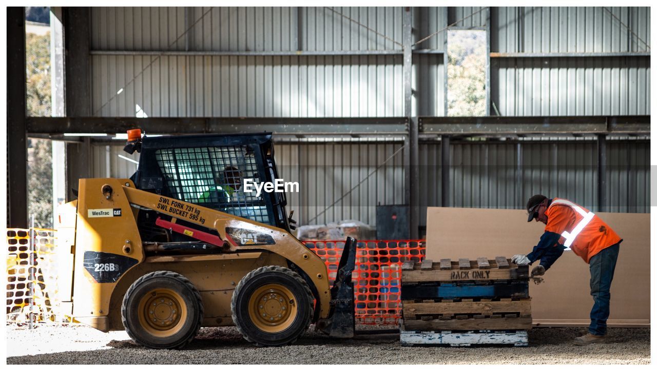 FULL FRAME SHOT OF MAN WORKING ON STEPS