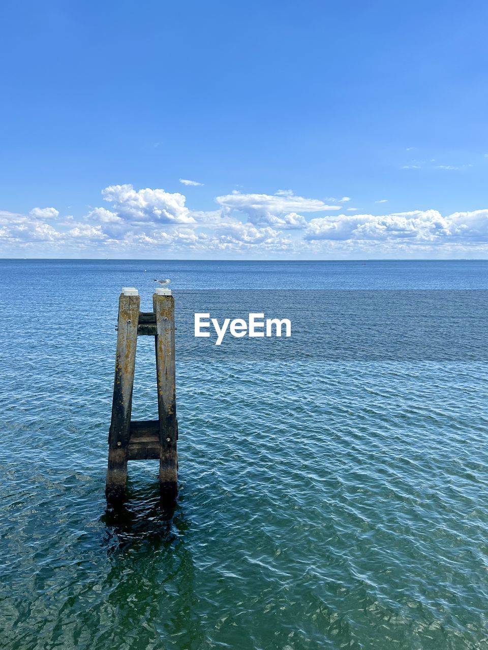 water, horizon, sea, ocean, sky, scenics - nature, shore, blue, nature, beauty in nature, bay, tranquility, coast, tranquil scene, no people, day, body of water, reflection, cloud, outdoors, land, travel destinations, travel, environment, architecture, non-urban scene, idyllic, vacation, wood, remote, landscape, reservoir