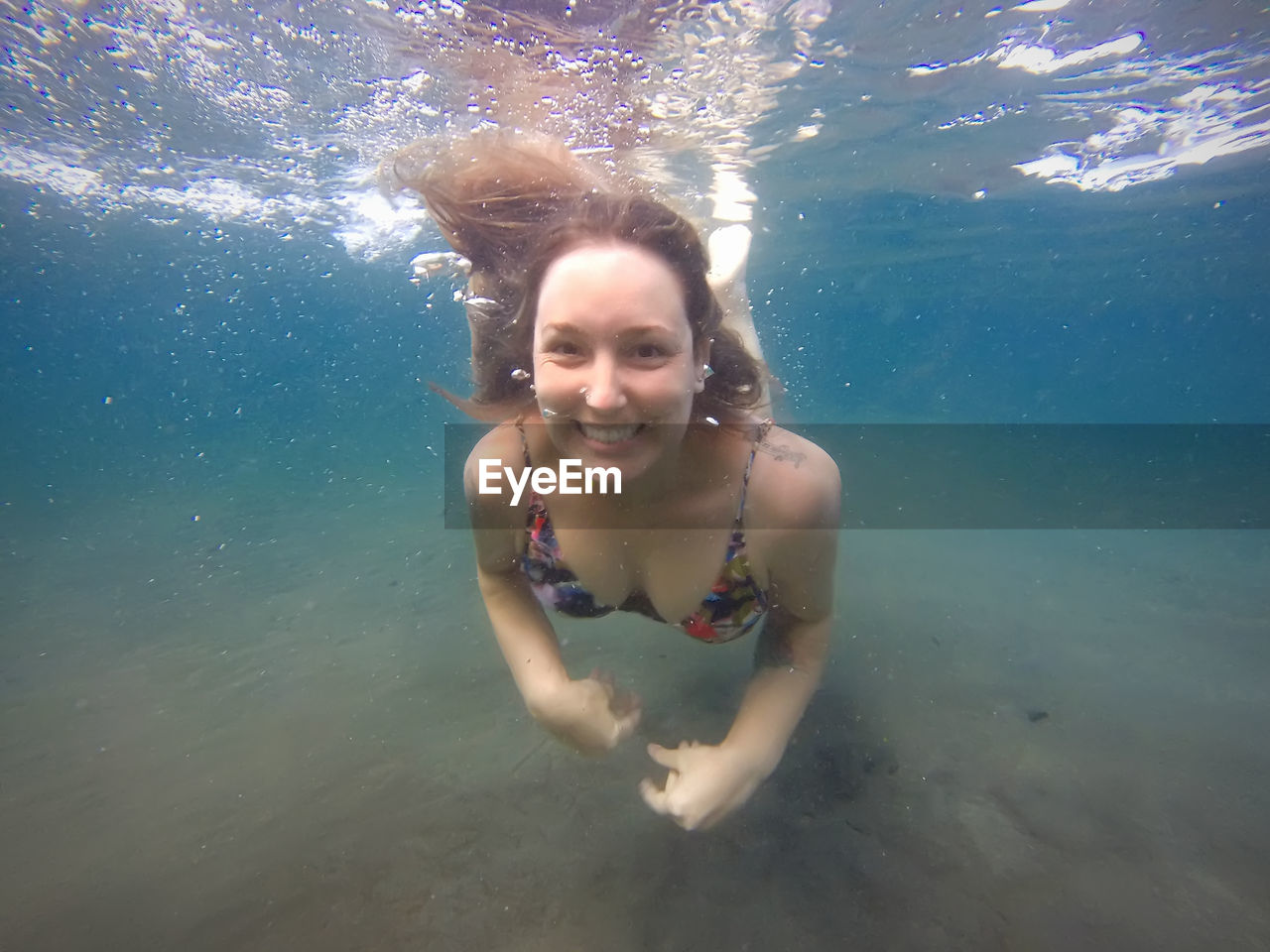 Portrait of smiling woman swimming in sea