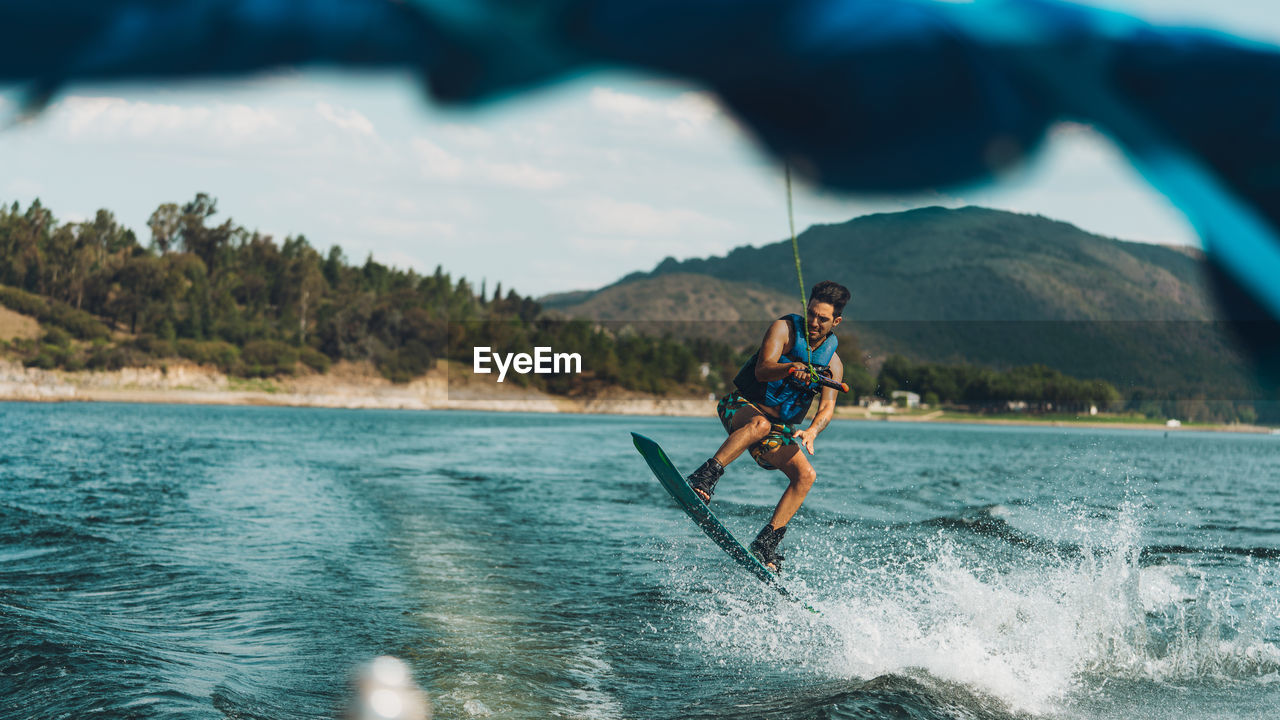 Full length of man doing wakeboard in a lake