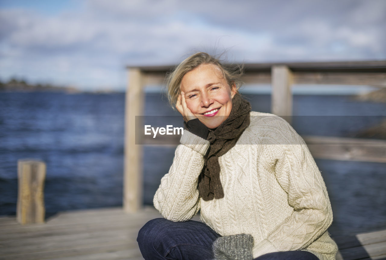 Smiling woman at lake