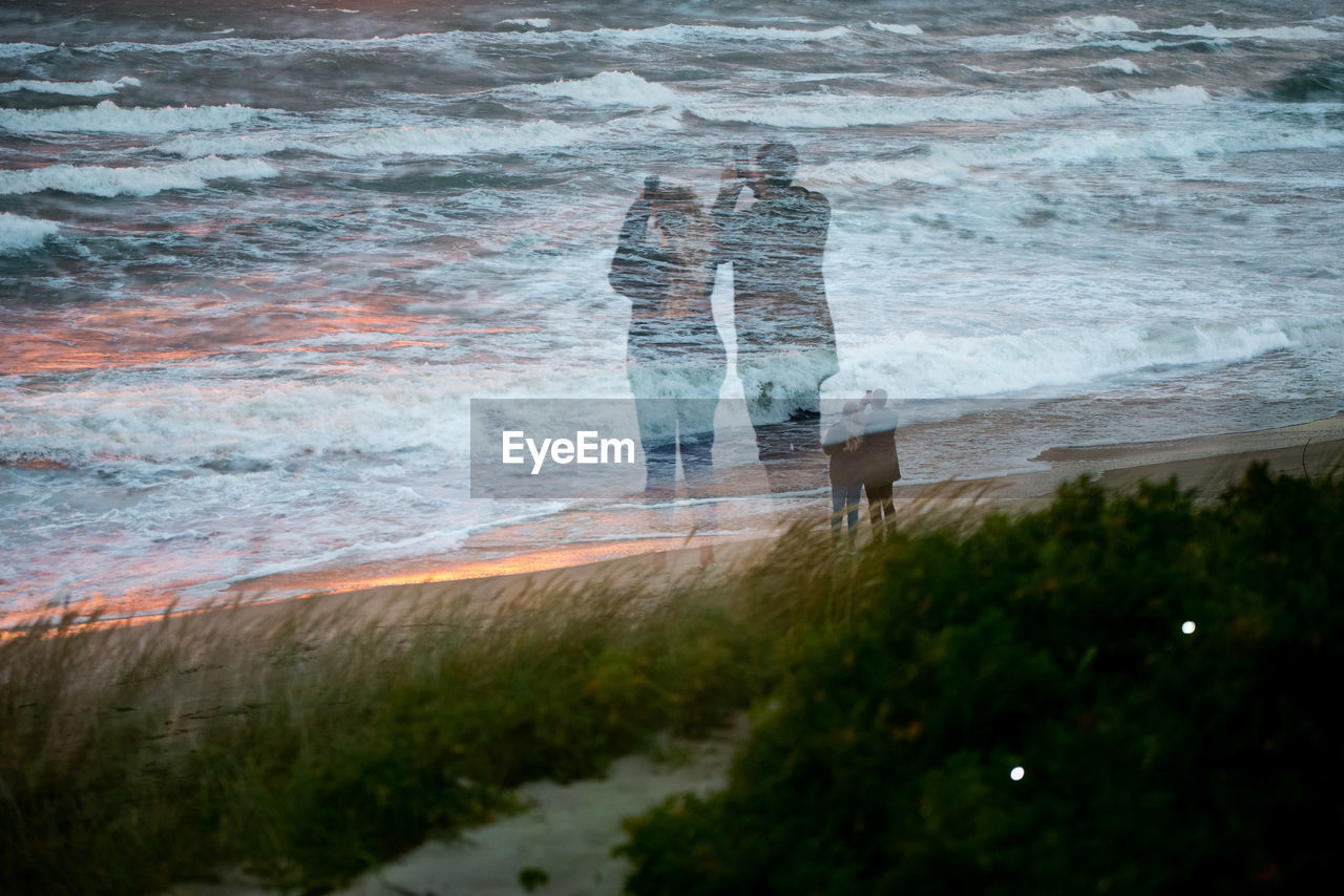 People on beach by sea