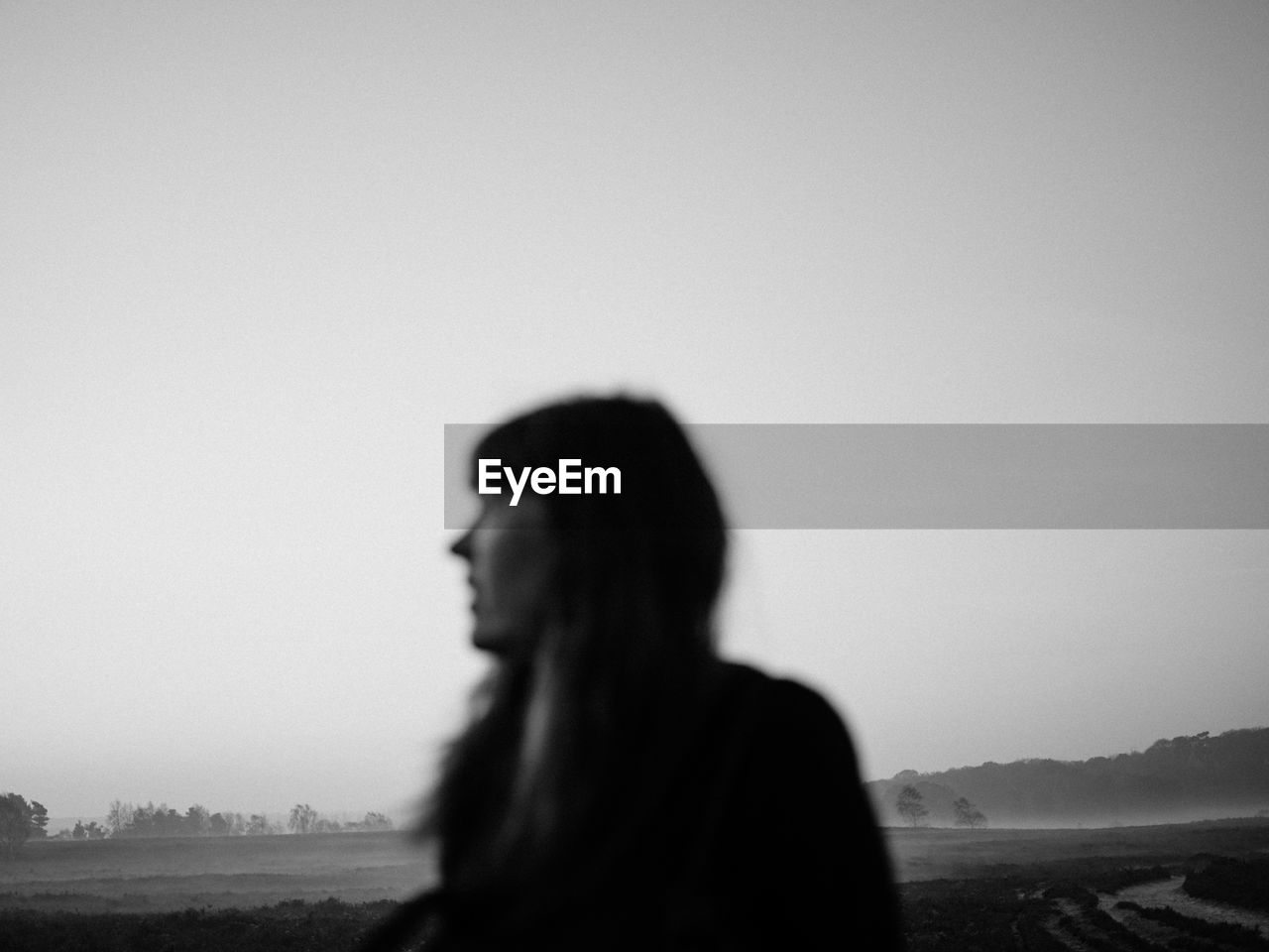 Defocused image of woman standing on field