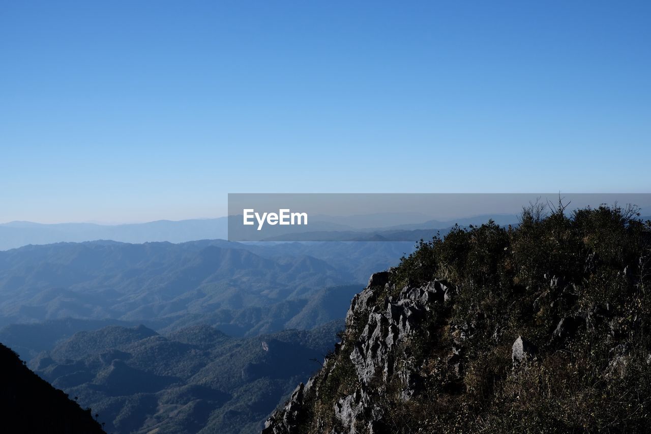 Scenic view of mountains against clear blue sky