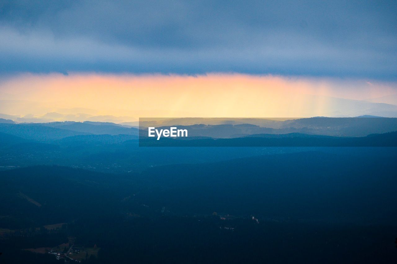 Scenic view of mountains against dramatic sky