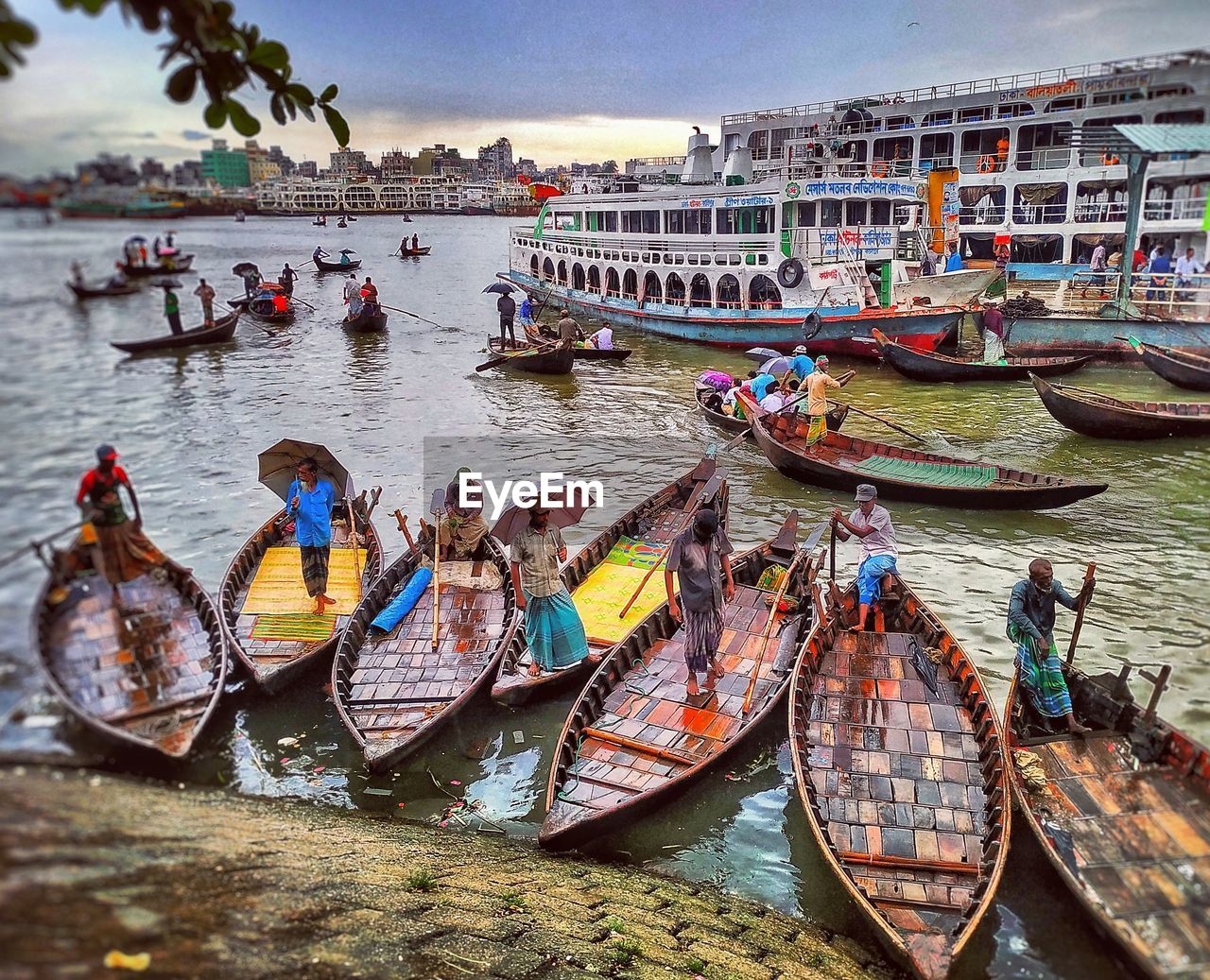 PEOPLE ON BOATS MOORED IN CANAL