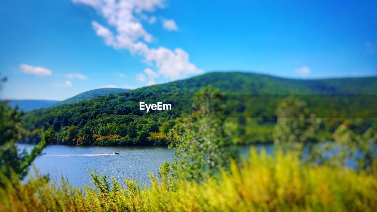 VIEW OF LAKE AGAINST CLOUDY SKY